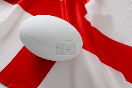 Téléchargez les photos : Ballon de rugby blanc sur le drapeau de l'Angleterre. Rugby, sport, international, compétition et jeux image générée numériquement. - en image libre de droit