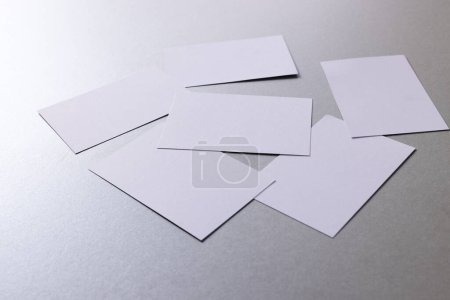 Foto de White business cards with copy space on grey background. Business, business card, stationery and writing space digitally generated image. - Imagen libre de derechos