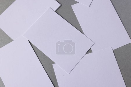 Foto de White business cards with copy space on grey background. Business, business card, stationery and writing space digitally generated image. - Imagen libre de derechos