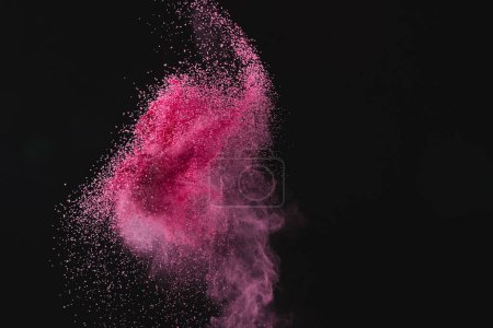 Photo for Close up of pink sand thrown in the air and copy space on black background. Time, timekeeping, shape and colour concept. - Royalty Free Image