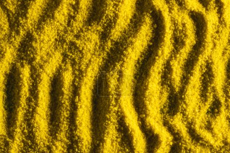 Photo for Close up of pattern of yellow sand and copy space background. Sand, texture, movement, shape and colour concept. - Royalty Free Image