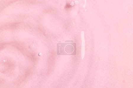 Foto de Primer plano de ondulaciones y olas de agua con espacio para copiar sobre fondo rosa. Concepto de agua, líquido y color. - Imagen libre de derechos