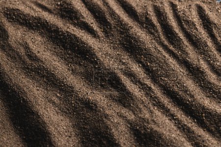 Photo for Close up of pattern of brown sand and copy space background. Sand, texture, movement, shape and colour concept. - Royalty Free Image