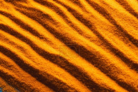 Photo for Close up of pattern of orange sand and copy space background. Sand, texture, movement, shape and colour concept. - Royalty Free Image