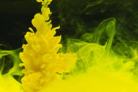 Photo for Close up of bright yellow ink in water with copy space on black background. Ink, liquid, shape and colour concept. - Royalty Free Image