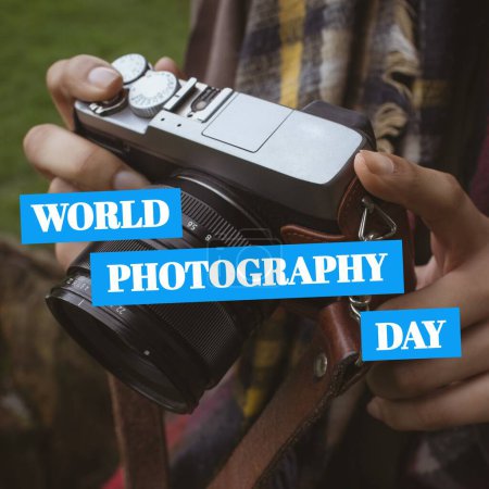 Photo for World photography day text on blue over hands of biracial woman using camera outdoors. Global celebration of photography campaign, digitally generated image. - Royalty Free Image