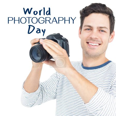 Téléchargez les photos : Journée mondiale de la photographie texte en bleu avec un homme caucasien souriant tenant appareil photo. Célébration mondiale de la campagne photographique, image générée numériquement. - en image libre de droit