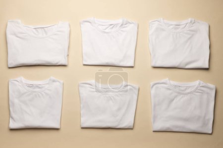 Foto de Primer plano de camisetas blancas dobladas y espacio de copia sobre fondo amarillo. Moda, ropa, color y concepto de tela. - Imagen libre de derechos