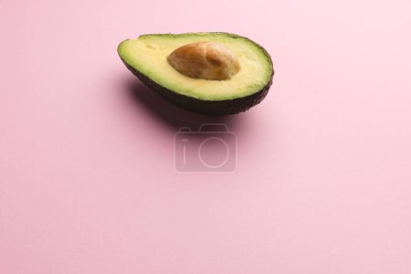 Photo for Close up of half of avocado and copy space on pink background. Vegetable, food, freshness and colour concept. - Royalty Free Image