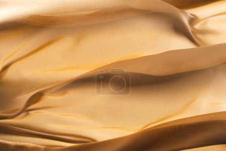 Photo for Close up of gold shiny silk fabric with copy space background. Texture, fabric, cloth, colour and material. - Royalty Free Image