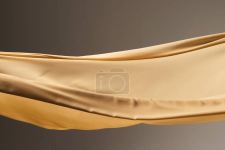 Photo for Close up of gold shiny silk fabric with copy space on black background. Texture, fabric, cloth, colour and material. - Royalty Free Image