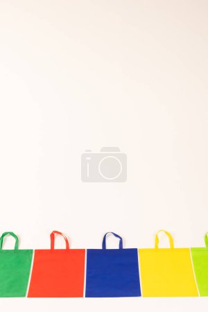 Photo for Row of multi colour canvas bags with copy space on white background. Shopping, bag, colour, fabric, texture and materials concept. - Royalty Free Image
