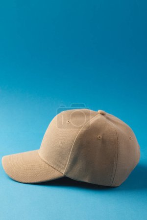 Photo for Cream baseball cap and copy space on blue background. Fashion, clothes, colour and fabric concept. - Royalty Free Image