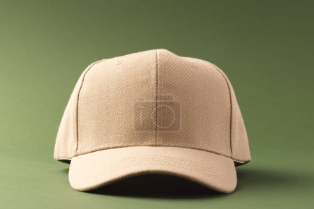 Photo for Cream baseball cap and copy space on green background. Fashion, clothes, colour and fabric concept. - Royalty Free Image