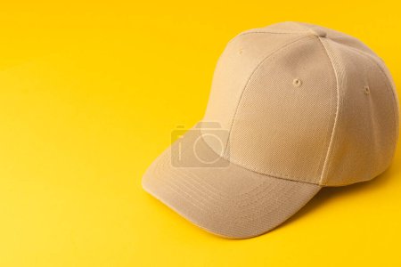 Photo for Cream baseball cap and copy space on yellow background. Fashion, clothes, colour and fabric concept. - Royalty Free Image