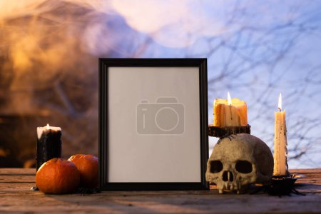 Photo for Black frame with copy space, skull, candles and smoke on black background. Halloween, colour, movement and smoke concept. - Royalty Free Image