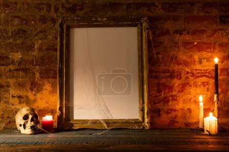 Photo for Black frame with copy space, skull, candles and smoke on brick wall background. Halloween, colour, movement and smoke concept. - Royalty Free Image
