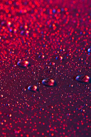 Photo for Micro close up of water drops with copy space on red background. Micro photography, liquid, texture and colour concept. - Royalty Free Image