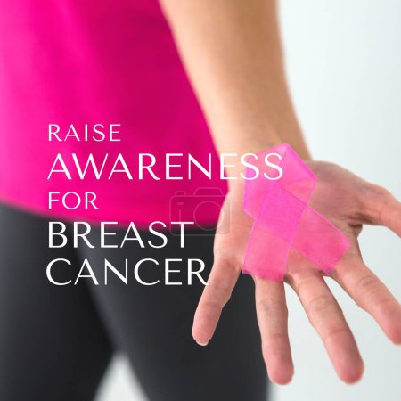 Photo for Composite of raise awareness for breast cancer text over hand of caucasian woman with pink ribbon. Pink october, medical, healthcare, support and prevention concept. - Royalty Free Image