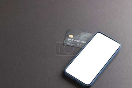 Photo for Smartphone with blank screen and credit card on black background. Cyber monday, cyber shopping, retail, technology, electronic device and communication concept. - Royalty Free Image