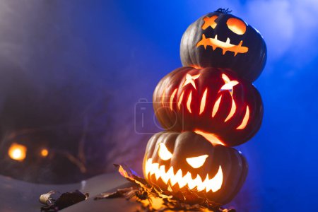 Photo for Carved pumpkins with copy space on blue background. Fall, autumn, halloween, tradition and celebration concept. - Royalty Free Image