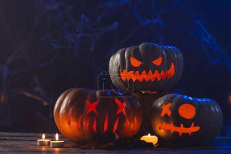 Photo for Carved pumpkins and candls with copy space on dark background. Fall, autumn, halloween, tradition and celebration concept. - Royalty Free Image