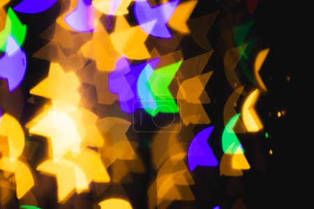 Photo for Multicoloured star bokeh lights with copy space on dark background. Light, colour and shape concept digitally generated image. - Royalty Free Image