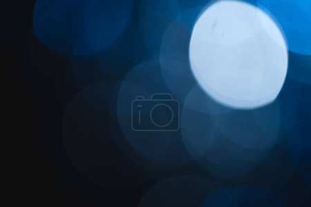 Photo for Blue bokeh lights with copy space on dark background. Light, colour and shape concept digitally generated image. - Royalty Free Image