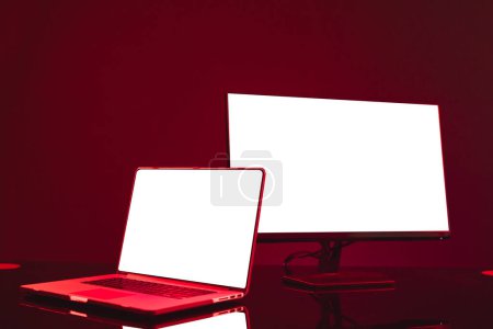 Photo for Composite of laptop and computer with copy space on neon background. Video game and digital connections concept digitally generated image. - Royalty Free Image