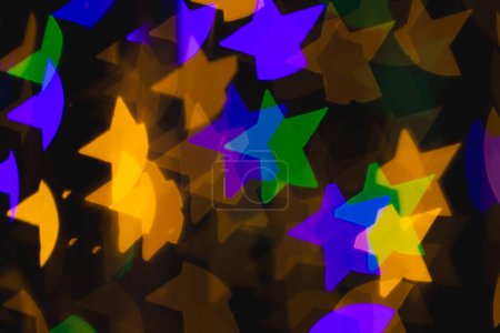 Photo for Multicoloured star bokeh lights with copy space on dark background. Light, colour and shape concept digitally generated image. - Royalty Free Image