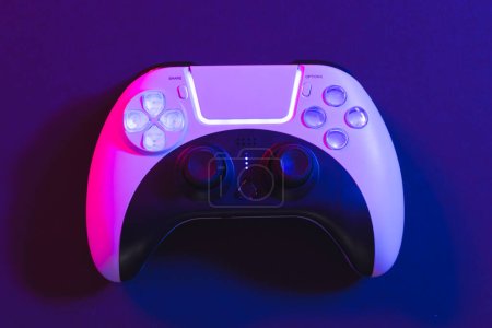 Photo for Composite of video game pad and copy space on neon background. Video game and digital connections concept digitally generated image. - Royalty Free Image