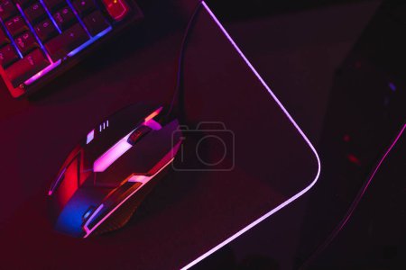 Photo for Composite of computer keyboard with video game accessories with copy space on neon background. Video game and digital connections concept digitally generated image. - Royalty Free Image