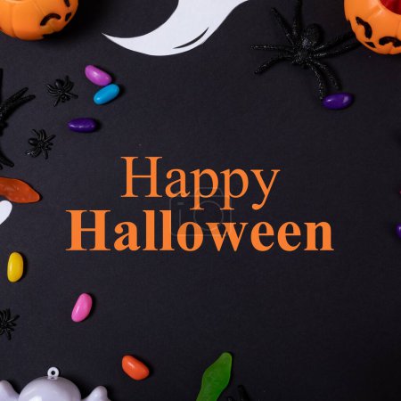 Photo for Composite of happy halloween text and halloween decorations on black background. Halloween, tradition and celebration concept digitally generated image. - Royalty Free Image