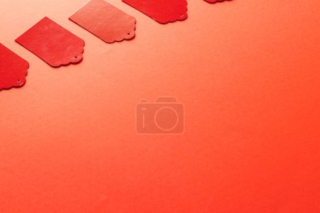 Photo for Row of red price tags with copy space on red background. Black friday, cyber monday, shopping, cyber shopping, sales, retail and shipping concept. - Royalty Free Image