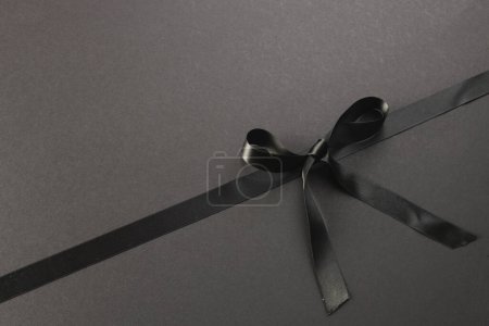 Photo for Black gift ribbon and bow with copy space on black background. Black friday, cyber monday, shopping, cyber shopping, sales, retail and shipping concept. - Royalty Free Image