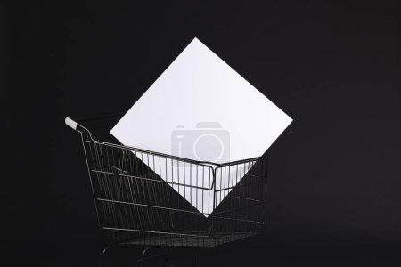 Photo for Shopping trolley with blank canvas and copy space over black background. Cyber monday, black friday, online shopping, shipping and global connections concept. - Royalty Free Image