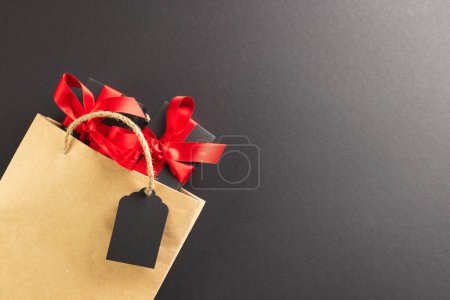 Photo for Gift boxes with ribbon, gift bag with copy space over black background. Cyber monday, black friday, online shopping, shipping and global connections concept. - Royalty Free Image