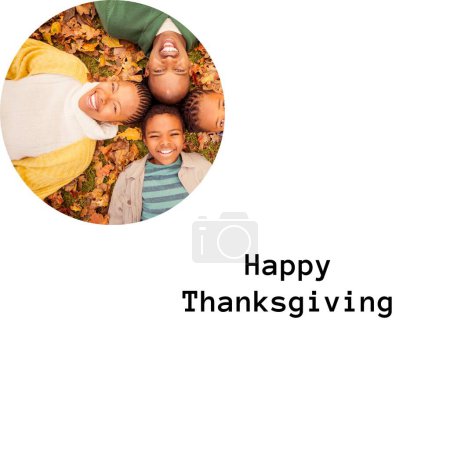 Photo for Happy thanksgiving text with happy african american family lying in autumn leaves. Thanksgiving, harvest festival, american tradition, family and autumn celebration digitally generated image. - Royalty Free Image
