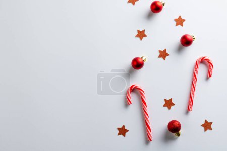 Photo for Christmas red baubles, stars and candy canes with copy space on white background. Christmas, decorations, tradition and celebration concept. - Royalty Free Image