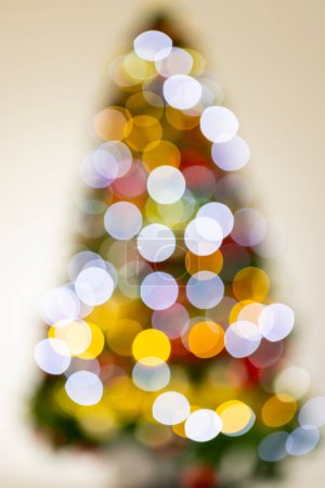Photo for Vertical image of out of focus christmas tree with fairy lights with copy space background. Christmas, decorations, tradition and celebration concept. - Royalty Free Image