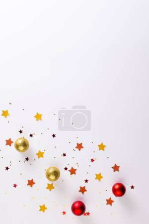 Photo for Vertical image of christmas stars, baubles decorations with copy space on white background. Christmas, decorations, tradition and celebration concept. - Royalty Free Image