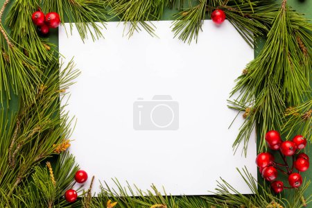 Photo for Christmas decorations and white card with copy space on green background. Christmas, decorations, tradition and celebration concept. - Royalty Free Image