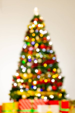Photo for Vertical image of out of focus christmas tree with fairy lights and gifts with copy space background. Christmas, decorations, tradition and celebration concept. - Royalty Free Image