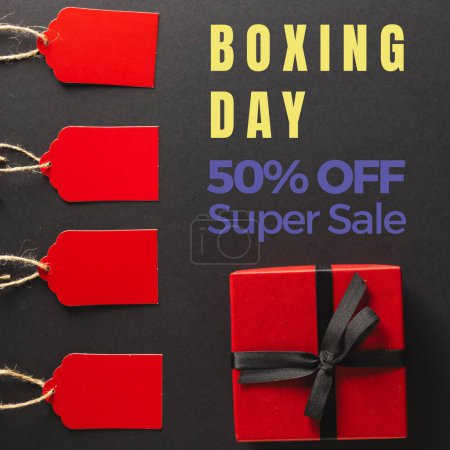 Photo for Composite of boxing day, 50 percent off, super sale over gift box and red tags on black background. Shopping, sale, surprise, text, discount, marketing, template, design, retail, advertise concept. - Royalty Free Image