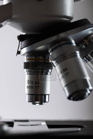 Photo for Vertical image of laboratory microscope and copy space on grey background. Laboratory, science, research and chemistry concept. - Royalty Free Image