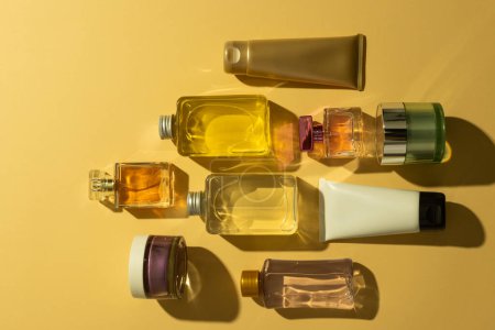 Photo for Flat lay of beauty products bottles, tub and tube with copy space on yellow background. Health and beauty, beauty product, make up and colour concept. - Royalty Free Image