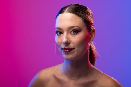 Photo for Portrait of caucasian woman wearing red lipstick and blue nail polish on purple background. Cosmetics, makeup, female fashion and beauty, unaltered. - Royalty Free Image