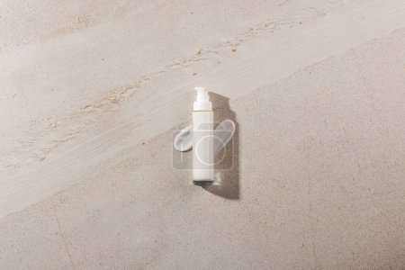 Photo for Beauty product bottle with pump and cream smudges with copy space on stone background. Health and beauty, make up and beauty concept. - Royalty Free Image