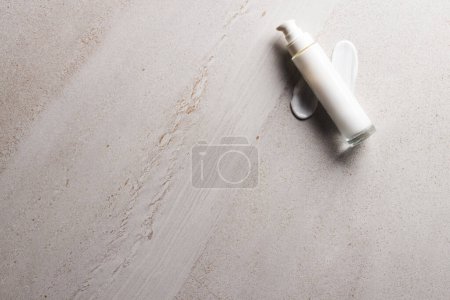 Photo for Beauty product white bottle with pump, smudges copy space on stone background. Health and beauty, make up and beauty concept. - Royalty Free Image