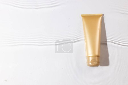 Photo for Beauty product tube in water with copy space background on white background. Health and beauty, make up and beauty concept. - Royalty Free Image